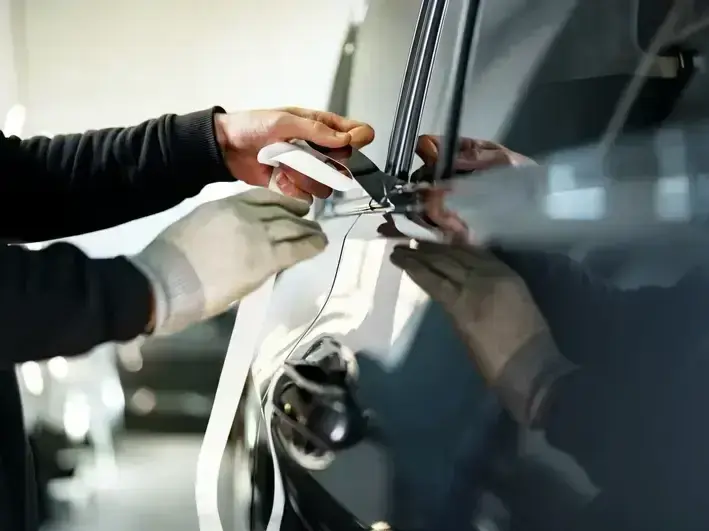 auto glass technician fixing crack damage for Shoreline commuter vehicle by Aurora Avenue North