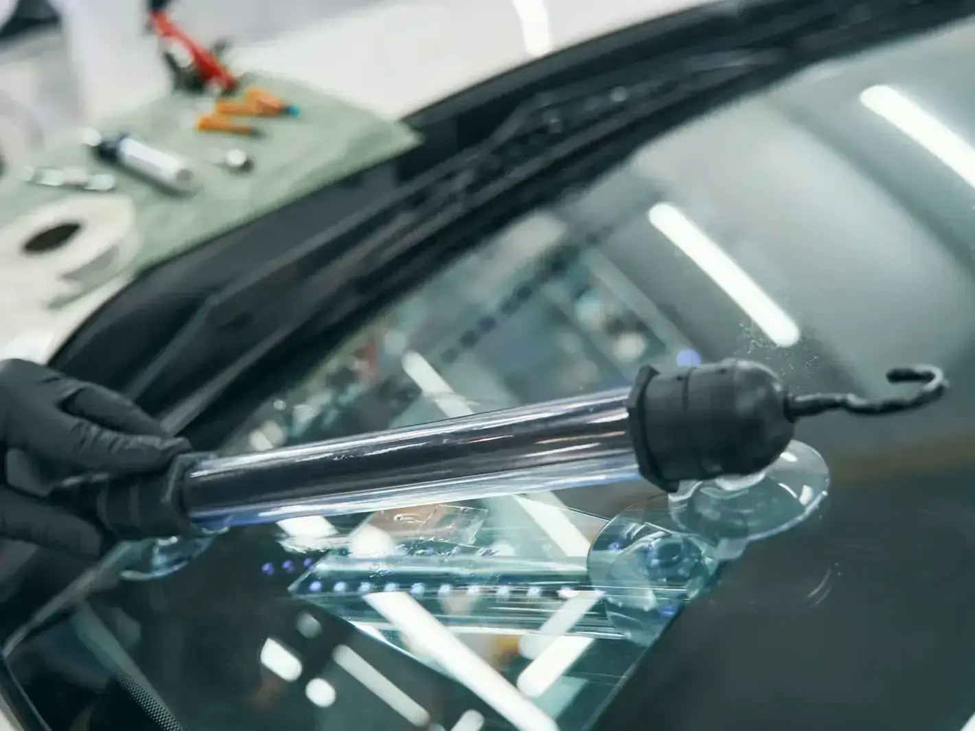 mobile windshield repair technician working on a cracked SUV windshield in Renton near Gene Coulon Memorial Beach Park