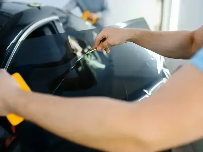 certified auto glass technician checking windshield seal and trim in downtown Renton near Rainier Avenue South