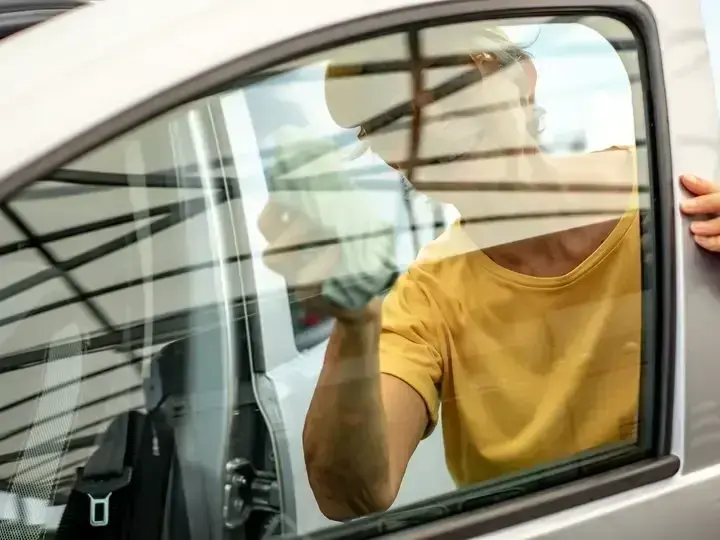 Seattle driver inspecting a freshly repaired windshield near the Space Needle landmark